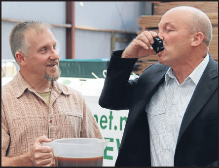 Andre Prassinos, left, watches Clutha District Mayor Bryan Cadogan enjoy his BioBrew sample
